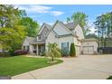 Well-maintained two-story home with lush lawn, featuring a three-car garage and neatly landscaped greenery at 229 Primstone Way, Mcdonough, GA 30253
