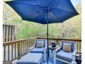 Inviting outdoor patio with comfortable seating and a large umbrella at 7920 Willoughby Ct, Alpharetta, GA 30005