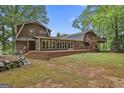 Spacious backyard featuring a large deck, ideal for outdoor entertaining and relaxation, with mature trees at 115 Ebenezer Church Rd, Fayetteville, GA 30215