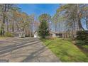 Spacious property with a charming home, multiple garages, and a long driveway, offering ample space and convenience at 150 Mary Lynn Ln, Fayetteville, GA 30214
