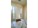 Bright foyer with tiled floors, sidelights, and neutral paint at 771 Franklin Mill Trce, Loganville, GA 30052