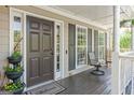 Charming front porch featuring a brown door, welcome mat, and comfortable seating with a view at 2515 Harbins Mill Dr, Dacula, GA 30019