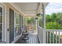 Inviting front porch with seating, a view, and a hanging flower basket, perfect for relaxing outdoors at 2515 Harbins Mill Dr, Dacula, GA 30019