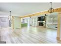 Spacious living room featuring hardwood floors, a brick fireplace, and open access to the kitchen at 1200 Ridgeway Rd, Covington, GA 30014