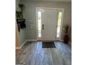 Inviting entryway with light gray flooring and a white front door with glass sidelights at 1164 Interlaken Pass, Jonesboro, GA 30238