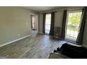 Open living room with tiled floors, large windows, and gray wall color at 1164 Interlaken Pass, Jonesboro, GA 30238