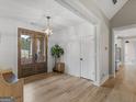 Inviting foyer boasts wood-look floors, shiplap accent walls, and a modern light fixture at 319 S Mount Carmel Rd, Mcdonough, GA 30253