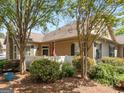 Exterior view of a home with a white fence, patio, neat landscaping, and a cozy outdoor seating area at 307 Gladstone Dr, Mcdonough, GA 30253
