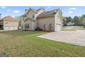 A spacious backyard with a well-maintained lawn and a view of the home's rear exterior at 225 Briarsweet Way, Fayetteville, GA 30215