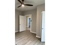 Neutral bedroom with modern ceiling fan, gray walls and wood-look floors at 116 Stewart Ave, Jonesboro, GA 30236