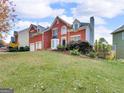 Charming two-story brick home with a two-car garage and a large, well-maintained front lawn at 3195 Vickery Ne Dr, Marietta, GA 30066