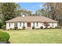 Beautiful single-story home with a well-manicured lawn, symmetrical landscaping, and an inviting front entrance at 110 Kylemore Pass, Tyrone, GA 30290