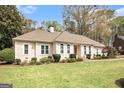 Traditional-style home with manicured lawn and mature trees at 110 Kylemore Pass, Tyrone, GA 30290