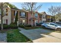 View of the front of several townhomes, each with driveways, greenery, and unique exterior designs at 11419 South Grove Dr, Hampton, GA 30228