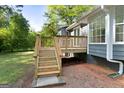 A wooden deck with stairs offers outdoor living space and backyard access at 653 Locust Rd, Locust Grove, GA 30248