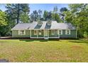 Inviting one-story home boasts a covered front porch, dormer windows, and ample natural light at 653 Locust Rd, Locust Grove, GA 30248