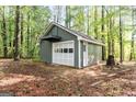 Detached garage with a white door and room for storage or hobbies at 653 Locust Rd, Locust Grove, GA 30248
