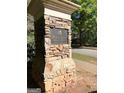Stone pillar with the HB Parkwood sign on a green lawn near the road at 1600 Prospect Pl, Locust Grove, GA 30248