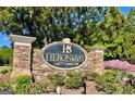 Stone monument sign for Heron Bay Golf & Country Club amidst lush greenery at 1600 Prospect Pl, Locust Grove, GA 30248