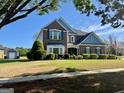 Inviting two-story brick home with manicured front lawn and American flag waving at 1600 Prospect Pl, Locust Grove, GA 30248
