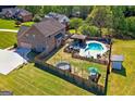 Aerial view of a spacious backyard featuring a pool, gazebo, and recreational area with trampoline at 4402 Kady Ct, Mcdonough, GA 30252