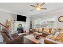Cozy living room with a fireplace, comfortable seating, and ample natural light at 4402 Kady Ct, Mcdonough, GA 30252