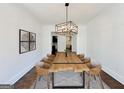 Bright dining room features a wooden table with seating for eight and modern light fixture at 906 Winall Down Ne Rd, Atlanta, GA 30319