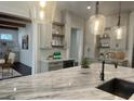 Gourmet kitchen with marble countertops, designer backsplash, and modern light fixtures at 906 Winall Down Ne Rd, Atlanta, GA 30319