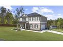 Spacious home boasts a well-manicured lawn, brick and siding exterior, with an attached two car garage at 924 Bryson Lake Cir, Douglasville, GA 30134