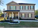 Charming home with covered front porch featuring brick and siding exterior, and well manicured lawn at 924 Bryson Lake Cir, Douglasville, GA 30134