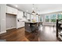 Bright kitchen with a large island, white cabinets, stainless steel appliances, and modern pendant lighting at 1341 Rosen Rd, Brookhaven, GA 30319