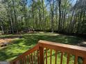 A spacious backyard with tall trees and a glimpse of a red storage shed at 149 Wimberly Way, Powder Springs, GA 30127