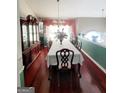 Formal dining room featuring a chandelier, large china cabinet, and a long table for hosting dinner parties at 3870 Michaels Creek Ct, Loganville, GA 30052