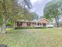 Lovely brick home with a blooming tree, fresh green lawn, and an inviting front porch at 103 Belair Ln, Stockbridge, GA 30281