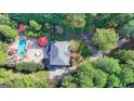 Aerial view of a home with a stunning pool area, lush landscaping, and a long private driveway at 2230 Cammie Wages Rd, Dacula, GA 30019