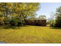 Expansive backyard featuring a well-maintained lawn and mature trees providing shade at 5183 Jones Ct, Morrow, GA 30260