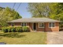 Charming single-story brick home with a well-maintained lawn and mature landscaping at 5183 Jones Ct, Morrow, GA 30260