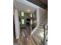 Inviting entryway showcasing hardwood floors, a staircase with iron railings, and views into the spacious living room at 935 S Laney Rd, Locust Grove, GA 30248