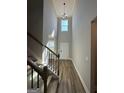 Bright entryway with hardwood floors, a high ceiling, and a staircase leading to the upper level at 935 S Laney Rd, Locust Grove, GA 30248