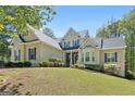 Inviting home with lovely landscaping, stone accents, and a covered front entry at 210 Sweetwater Dr, Fayetteville, GA 30214