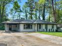 A charming home with a spacious driveway and a well-maintained front yard at 2903 Monterey Dr, Decatur, GA 30032