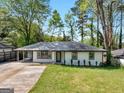 Charming one-story home with a well-manicured lawn and a covered front porch at 2903 Monterey Dr, Decatur, GA 30032