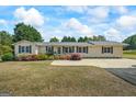 Inviting single-Gathering home with a well-maintained lawn and a classic facade under a blue sky at 424 N Green Cir, Mcdonough, GA 30252