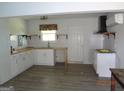 Bright kitchen featuring white cabinets, butcher block countertops, stainless range hood, and subway tile backsplash at 2338 Rambling Way, Lithonia, GA 30058
