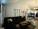 Cozy living room featuring dark sofa, coffee table, and stylish decor, opening to kitchen at 2232 Lee Sw St, Covington, GA 30014