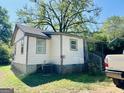 Rear exterior of home featuring an AC unit, white siding, and convenient covered back entry at 2232 Lee Sw St, Covington, GA 30014