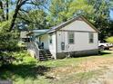 Exterior side view of a cozy home with a small covered porch and truck in the driveway at 2232 Lee Sw St, Covington, GA 30014