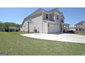 Well-maintained home with a basketball hoop, two car garage, and a neatly kept lawn at 609 Francis Ave, Peachtree City, GA 30269