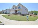 Inviting two-story home with landscaped front yard and charming curb appeal on a sunny day at 609 Francis Ave, Peachtree City, GA 30269