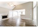 Bright living area with vaulted ceiling, fireplace and an open layout connecting to the dining and kitchen at 149 Camden Woods Pl, Dallas, GA 30157
